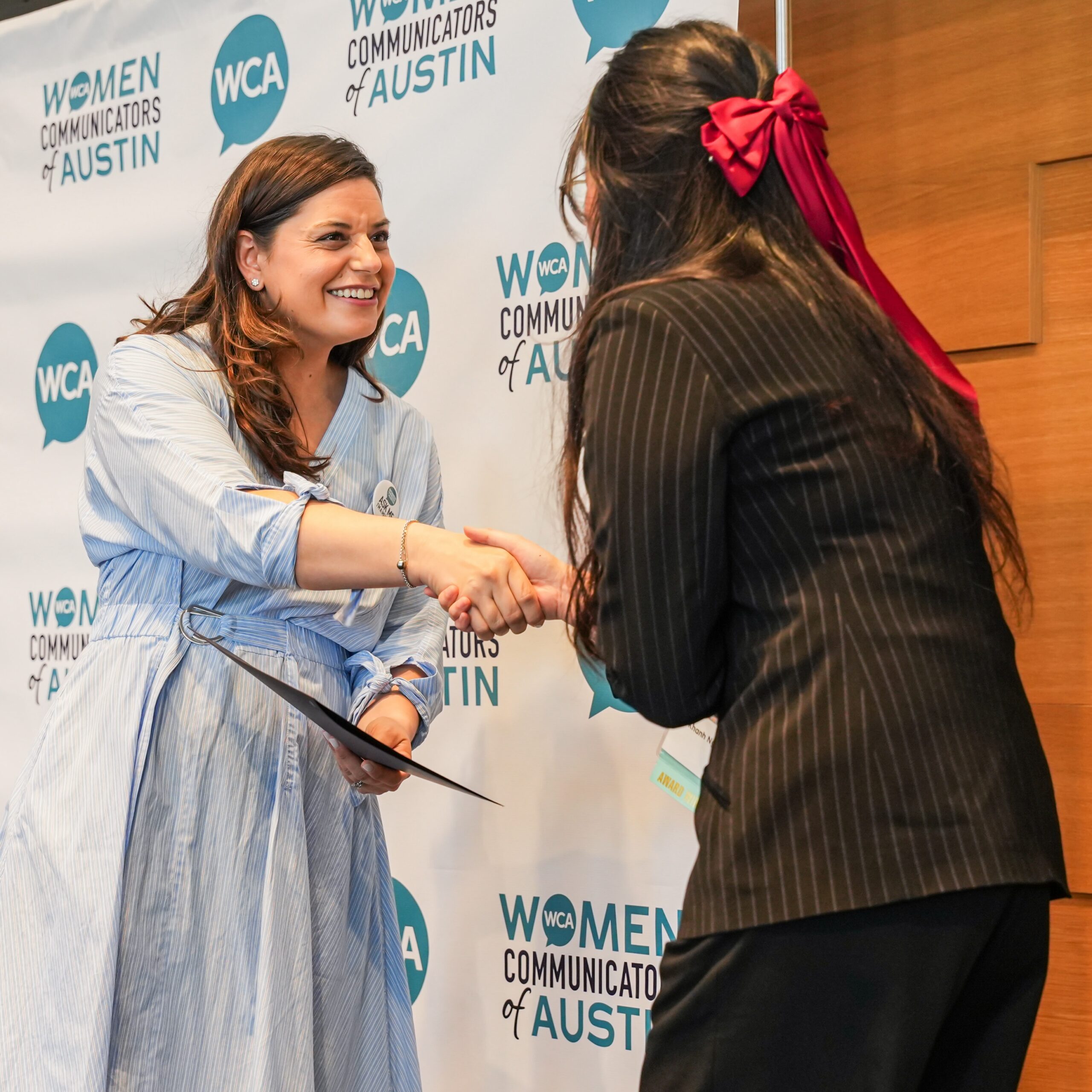 Two women holding a certificate