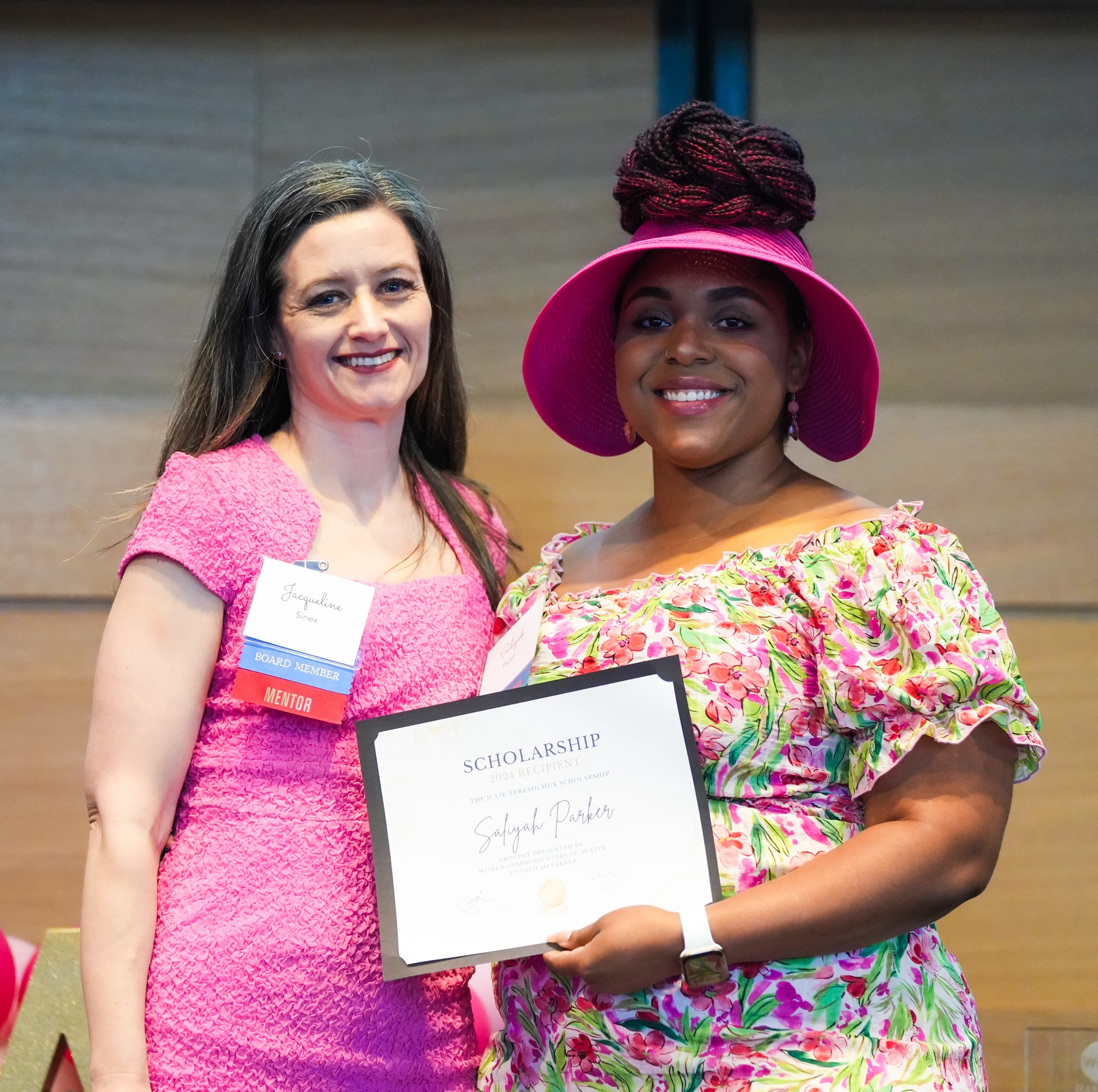 Two women holding a certificate